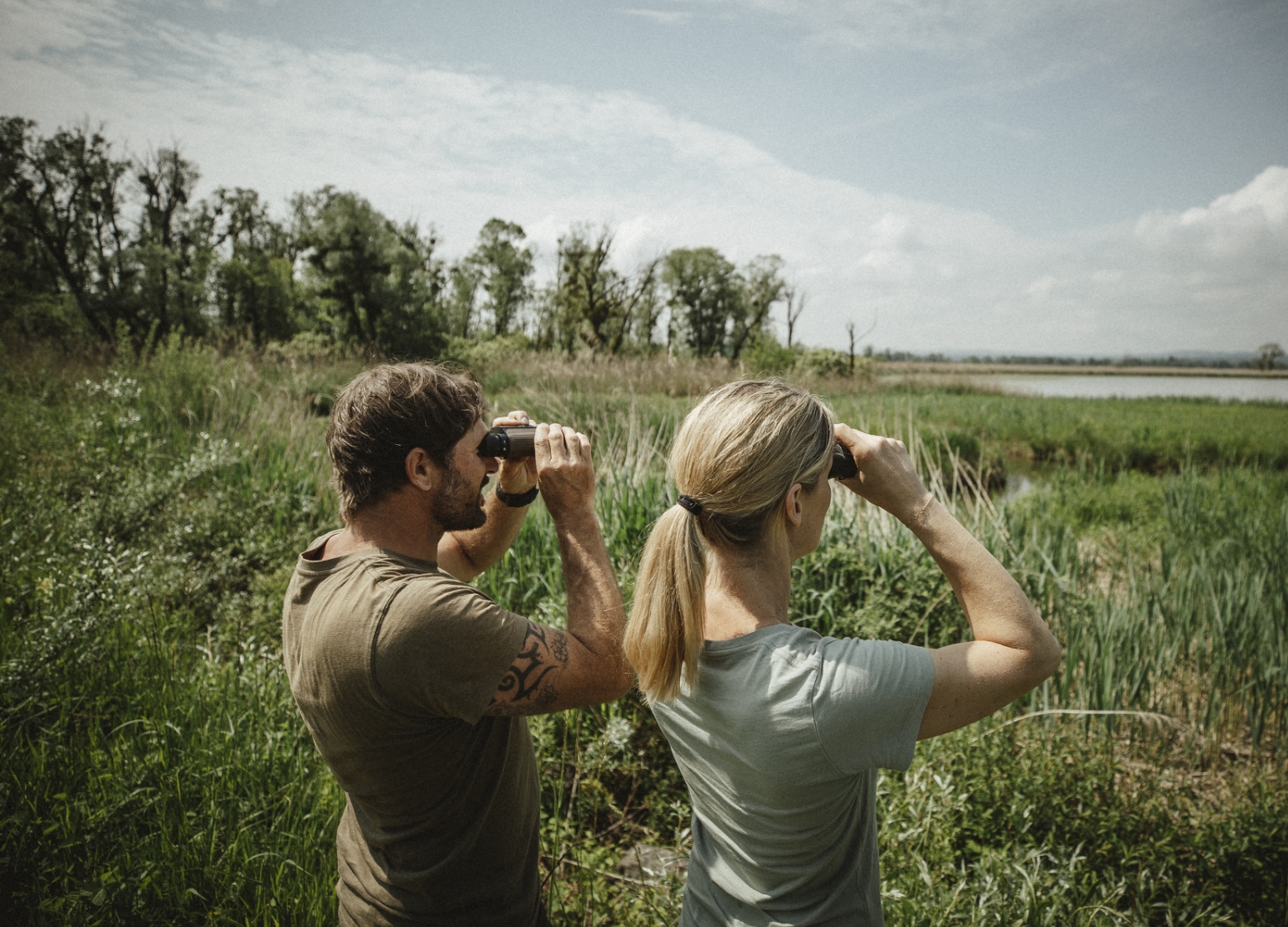 Hunter holding two Bone Collector Laser Rangefinders 1000 and 1800